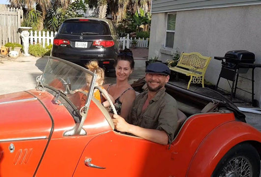 Beatrice, Alec, and Dino in her dad's red MG