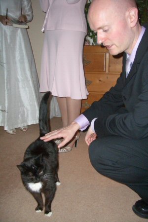 Gwen the cat  admires James' Suit